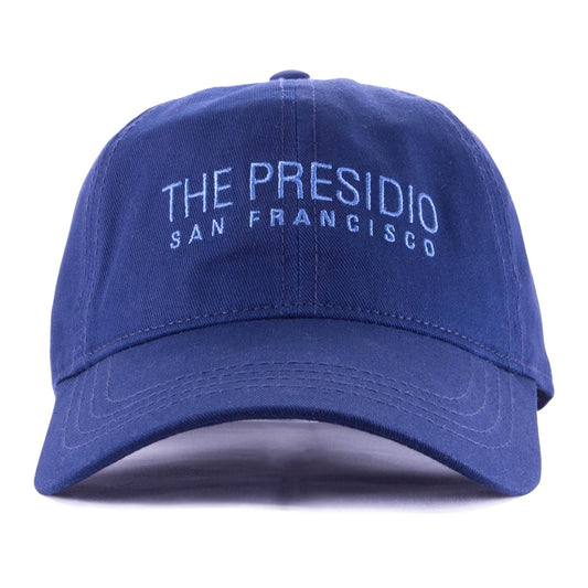 Blue baseball cap with blue The Presidio San Francisco words embroidered on front panels.