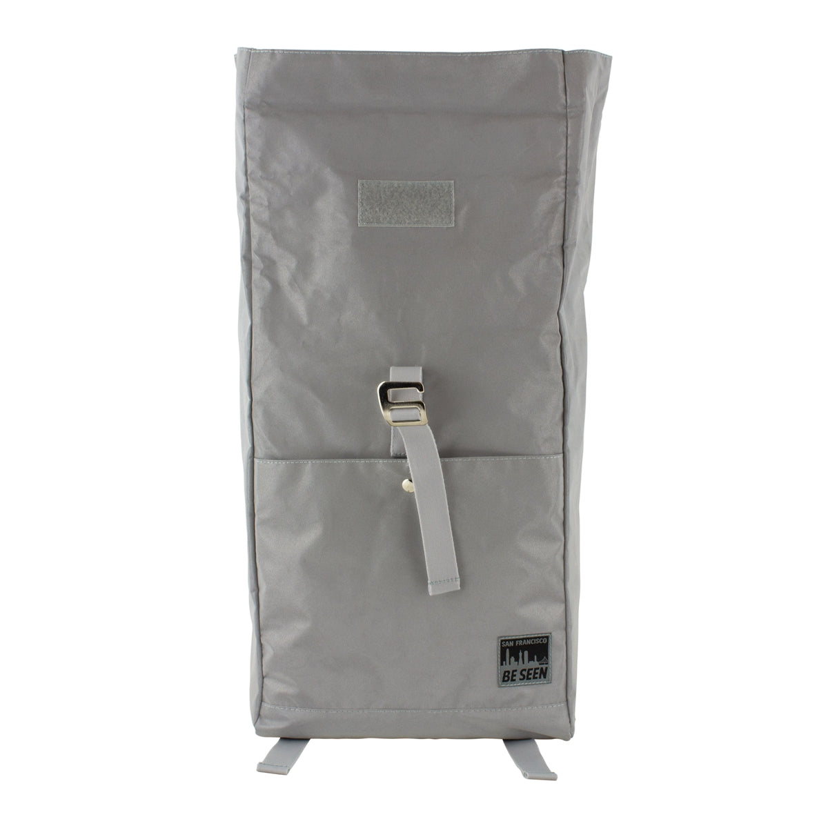Reflective grey backpack with black and grey San Francisco Be Seen logo on front pocket.