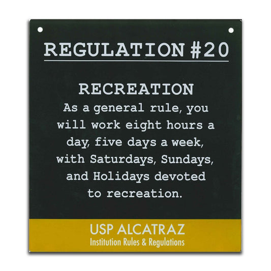 Black and yellow decorative metal sign with Alcatraz Regulation 20 ("you will work eight hours a day...") printed in white.