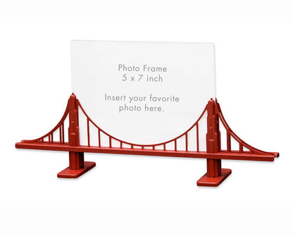 Red picture frame in the shape of the Golden Gate Bridge, holding a white card reading “Photo Frame 5 by 7 inch Insert your favorite photo here.”