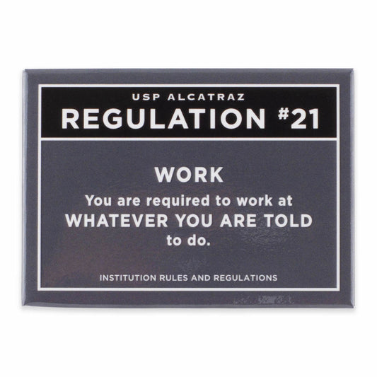 Rectangular dark grey magnet with text from U.S. Penitentiary Alcatraz Regulation 21 in white, with black accent: “You are required to work at whatever you are told to do.”