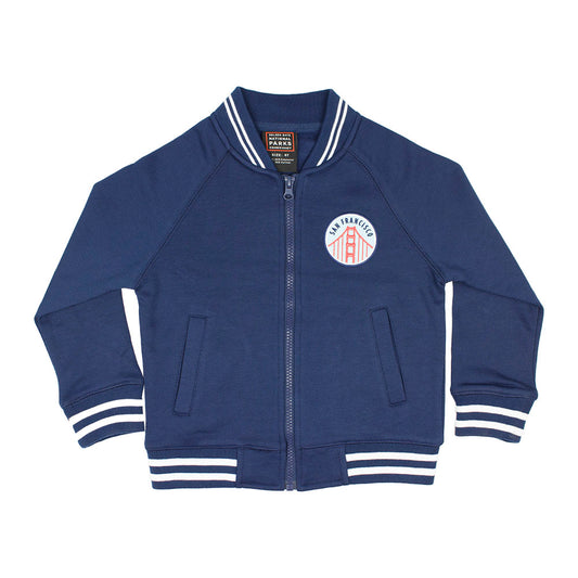 Blue kids varsity jacket with San Francisco Golden Gate Bridge logo on the chest against a white background