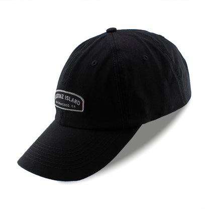 Black baseball cap with embroidered Alcatraz Island label on front panels.
