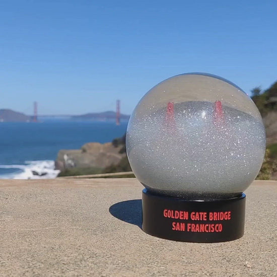Sparkling Golden Gate Bridge Fog Globe on a sunny day in front of the Golden Gate Bridge.