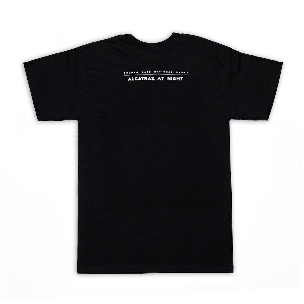 Black crew neck t-shirt with words "Golden Gate National Parks Alcatraz at Night" screen-printed in white on back panel.