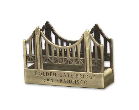 Metal business card holder shaped like the Golden Gate Bridge with embossed lettering.