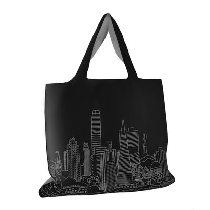Tote bag with San Francisco building illustration printed on body in white on black background.