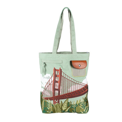 Pale green tote bag with colorful embroidered and printed design of the Golden Gate Bridge on front panel with pockets.