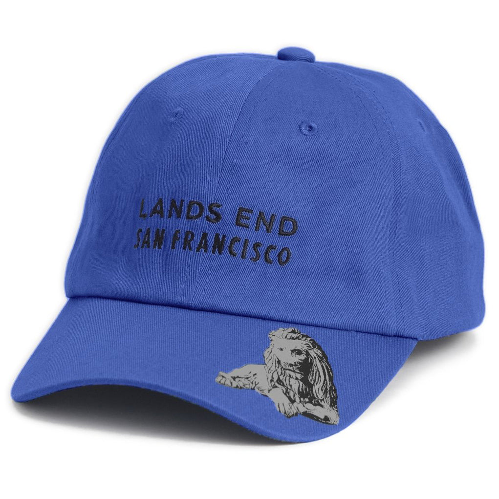 Blue baseball cap with embroidered Lands End San Francisco text on front panels and screen-printed design of lion on brim.
