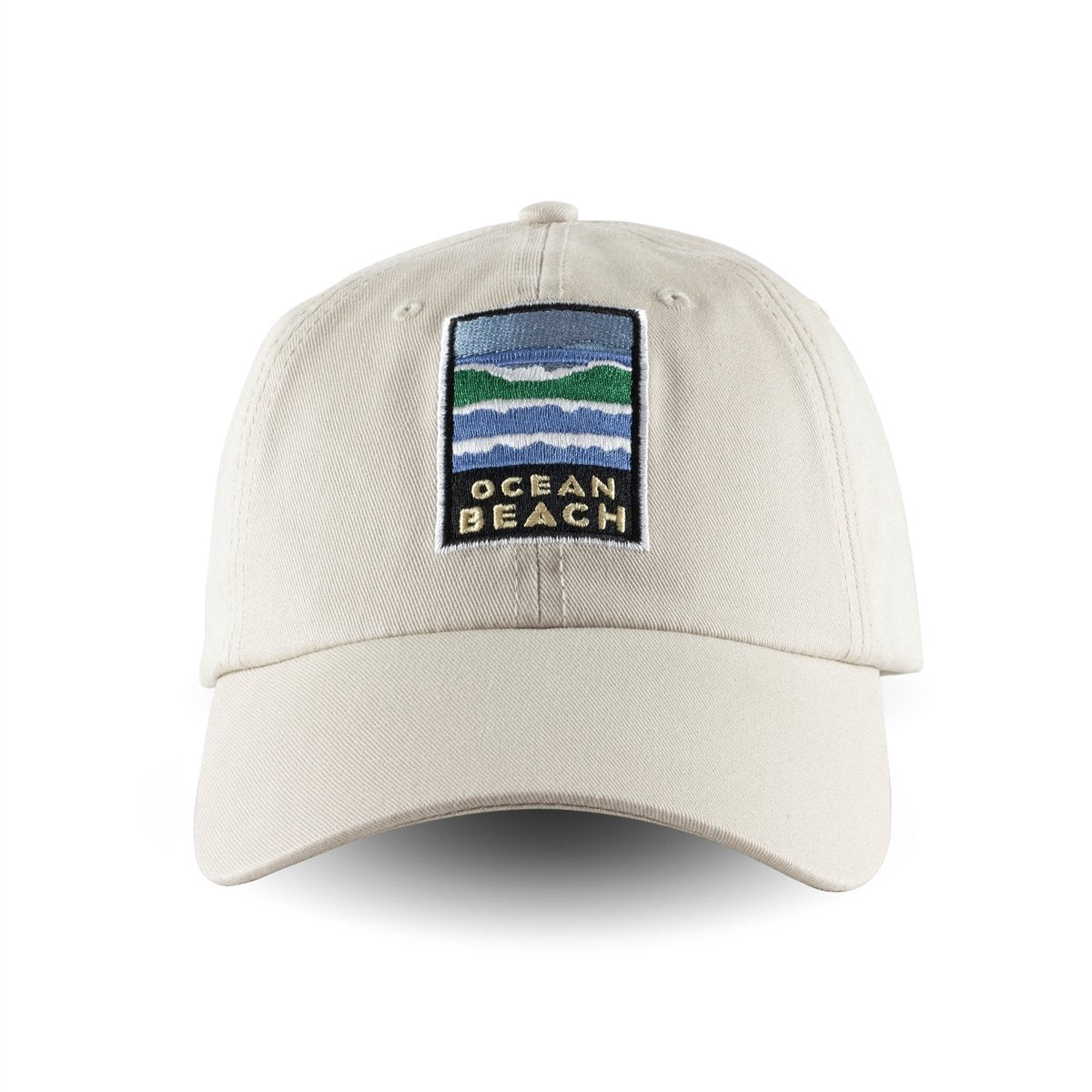 Tan baseball cap with colorful embroidered Ocean Beach logo on front panels. Artwork by Michael Schwab.