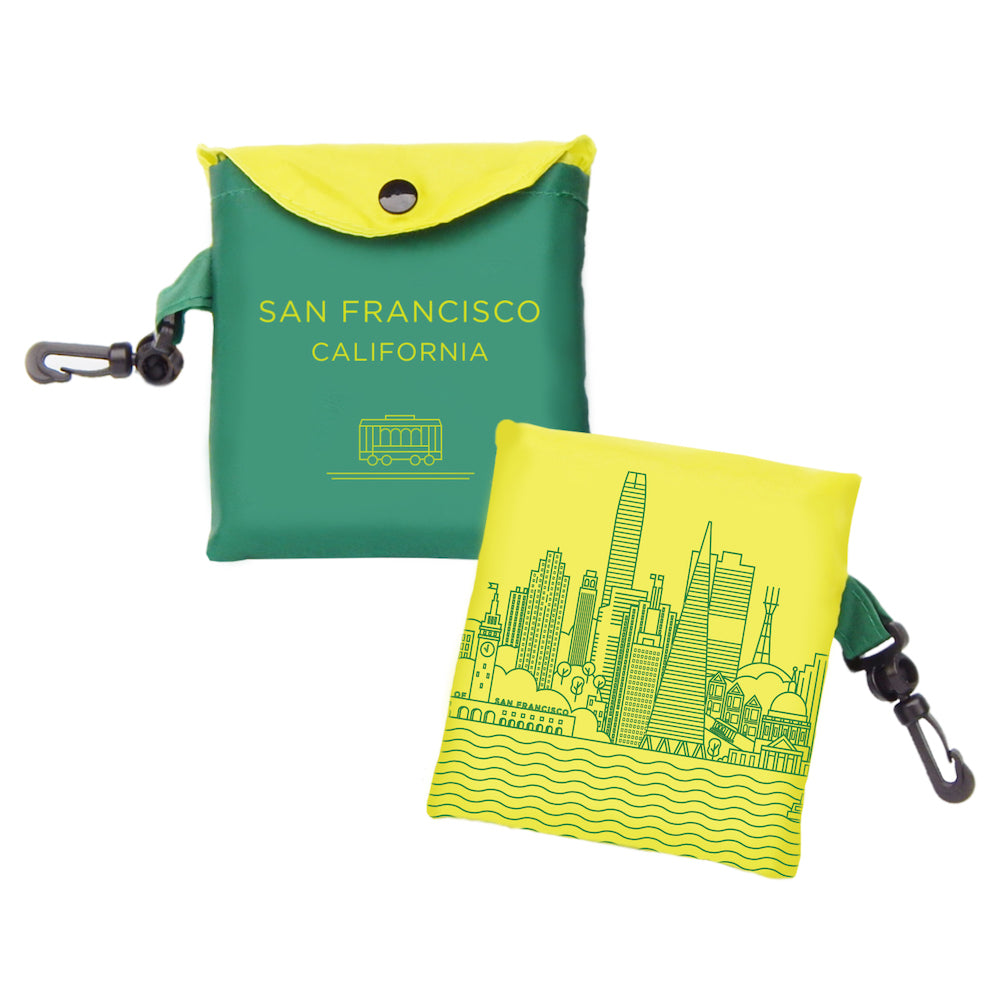 Tote bag with San Francisco California text and cable car image in green on one side and building illustration in yellow on other side.