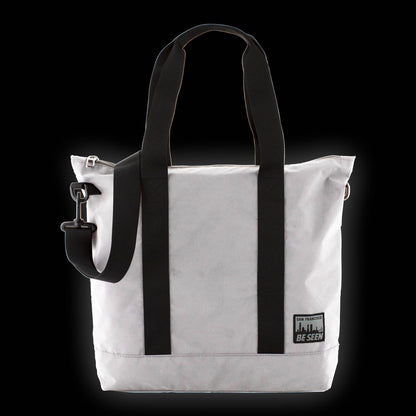 Reflective charcoal grey tote bag with black and grey San Francisco Be Seen logo.