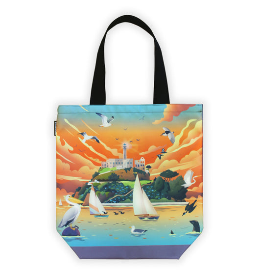 Brightly colored tote bag with whimsical illustration of Alcatraz Island featuring sailboats, pelicans, birds, and seagulls. Black handle.