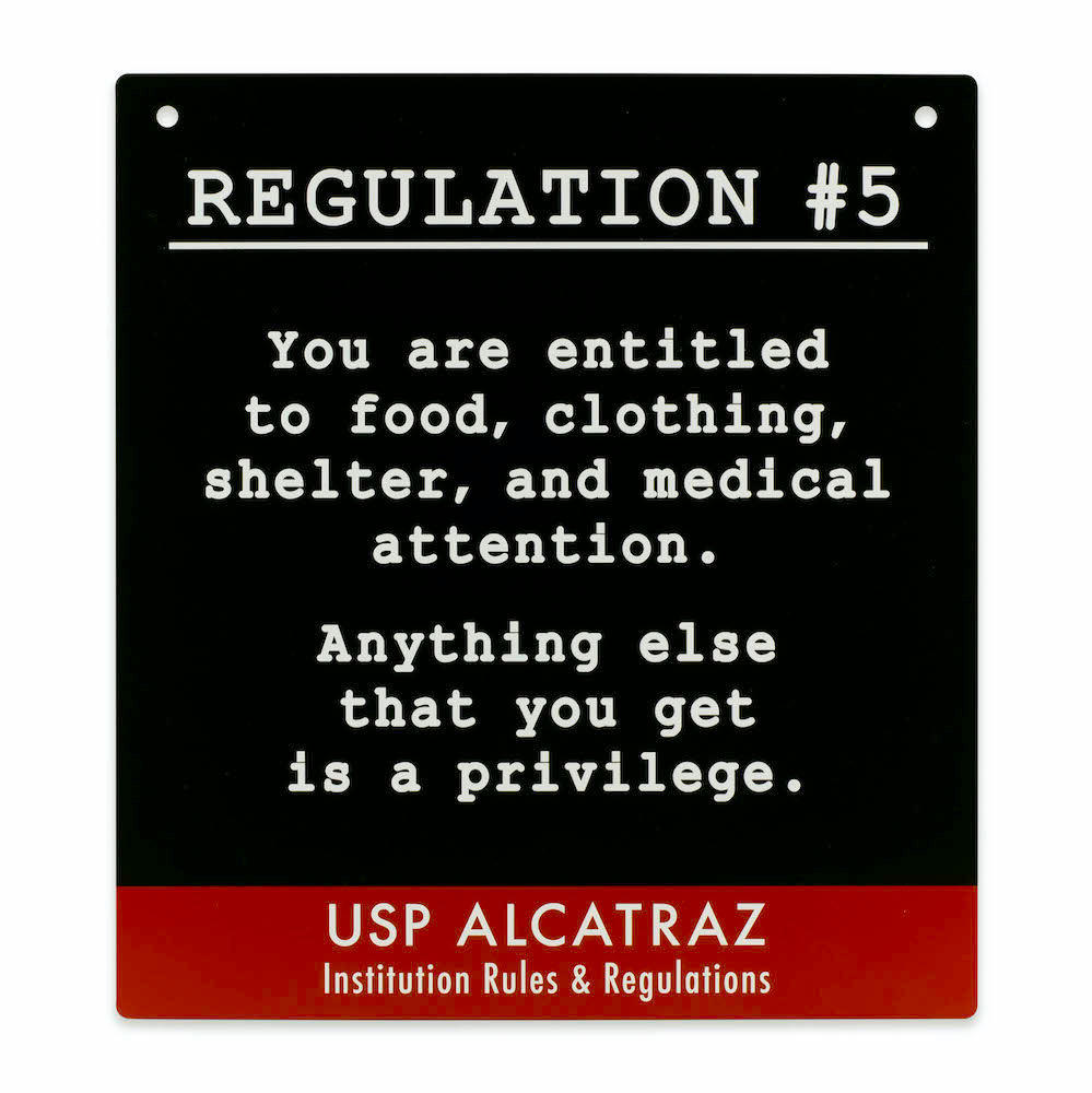 Black decorative metal square sign with Alcatraz Regulation 5 ("You are entitled to food, clothing...") printed in white. Red accent.