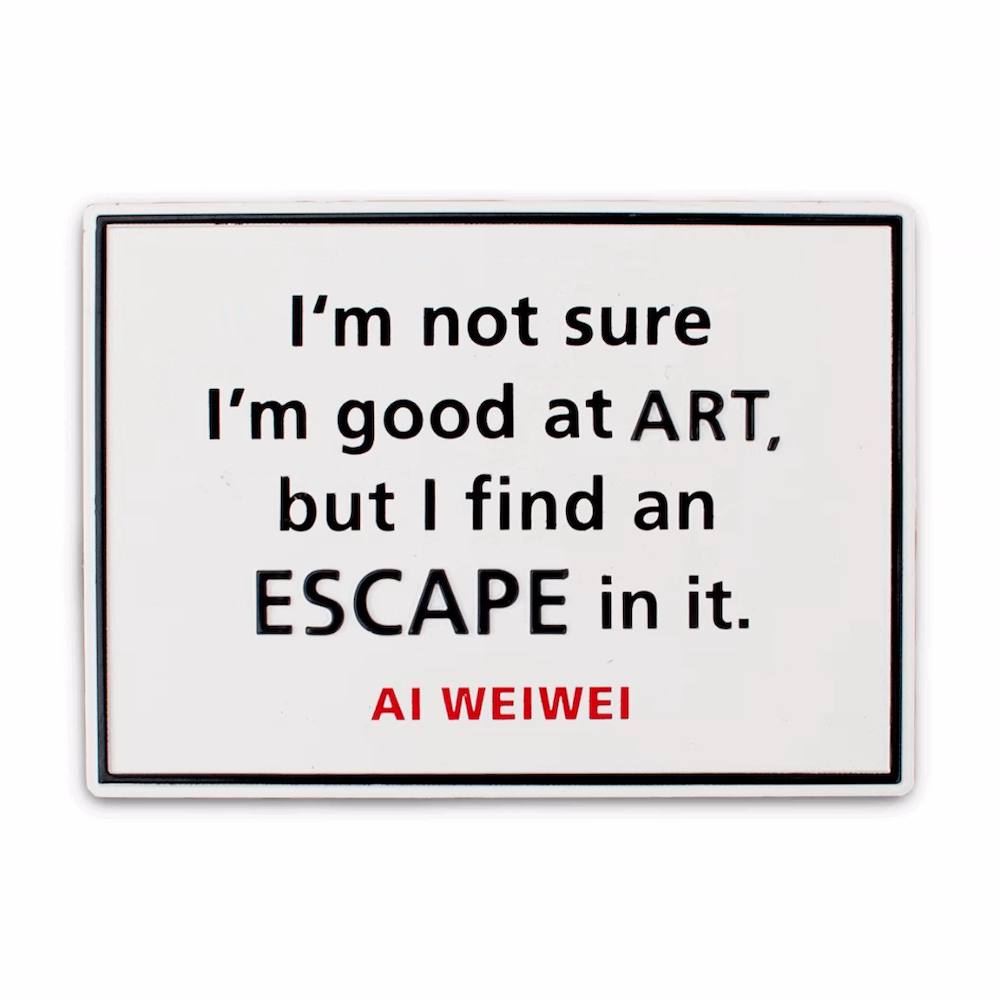 Magnet from @Large Ai WeiWei on Alcatraz exhibit, black text on white background reads "I'm not sure I'm good at ART, but I find an ESCAPE in it."