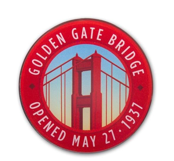 Multicolor round lapel pin featuring Golden Gate Bridge Art Deco tower design with opening date, May 27, 1937.