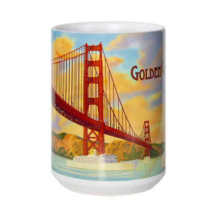 White ceramic 15-ounce mug featuring a colorful illustration of San Francisco's Golden Gate Bridge at sunset. The sky is lit with colorful orange clouds, while boats sail on the tranquil aqua blue waters of the bay.