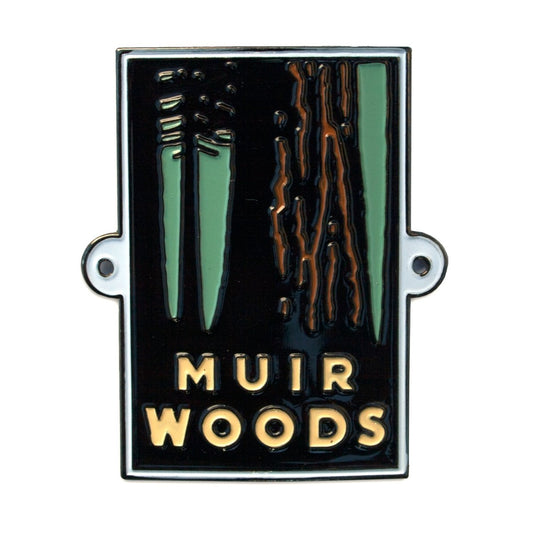 Multicolor souvenir metal hiking stick medallion with design of Muir Woods trees, based on artwork by Michael Schwab.