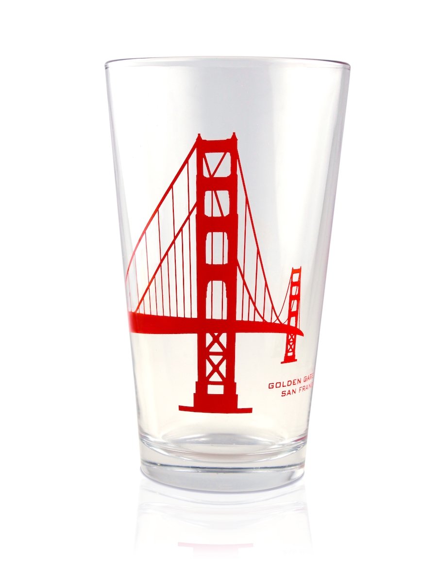 16 oz. Golden Gate Bridge pint glass, with red-orange printed bridge silhouette design on colorless glass. Made in the USA.