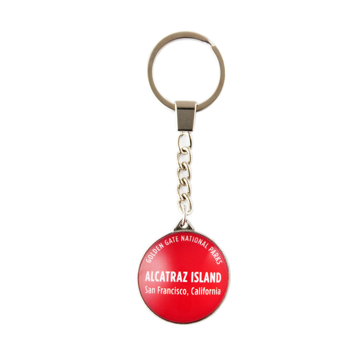 Colorful Alcatraz souvenir crystal keychain with text "Golden Gate National Parks Alcatraz Island San Francisco, California" in white on red background.
