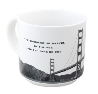 14 oz. white mug with black-and-white photo of the Golden Gate Bridge and "The Engineering Marvel of the Age" in black text.